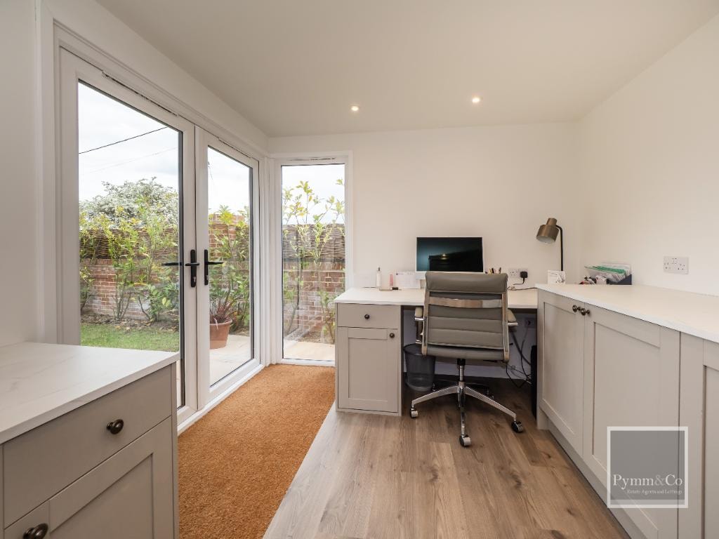 Malthouse refurbishment — home office with fitted shaker cabinetry, oak flooring and French doors to garden